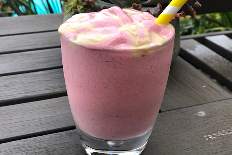 Glass of Sneaky PB&J Smoothie with Undercover Veggies with a strawberry garnish