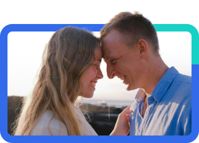 Couple smiling at each other outside.